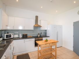 A kitchen with cabinets, appliances, and a kitchen island at Portland View in Portland Bill