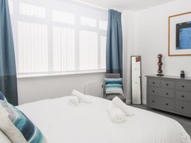 A bedroom with a bed and a mirror at Portland View in Portland Bill