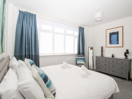 A bedroom with a bed and dressing table at Portland View in Portland Bill