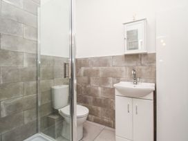 A bathroom with a shower, toilet, and sink at Portland View in Portland Bill