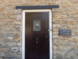 A front door with stone wall at Honeypot Cottage in Weymouth