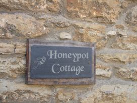 A sign reading Honeypot Cottage on a stone wall at Honeypot Cottage in Weymouth