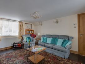 A living room with a sofa and coffee table at Honeypot Cottage in Weymouth
