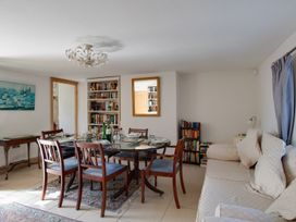 A dining room with a table and chairs at Honeypot Cottage in Weymouth