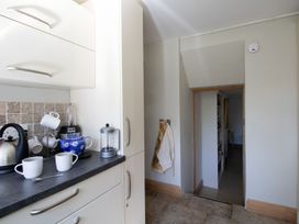 A kitchen with a kettle and blender on the counter at Honeypot Cottage in Weymouth