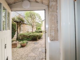 A view from the entrance showing a pathway and greenery at Longfords Mill near Nailsworth