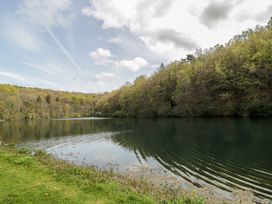 A lake surrounded by trees at Longfords Mill near Nailsworth