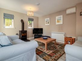 A living room with a television and coffee table at Stowaway Cottage in Padstow