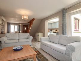 A living room with sofas and a coffee table at Stowaway Cottage in Padstow