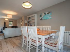 A dining room with a table and chairs at Stowaway Cottage in Padstow