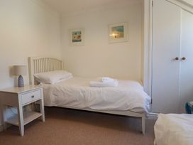 A bedroom with a bed and a bedside table at Stowaway Cottage in Padstow