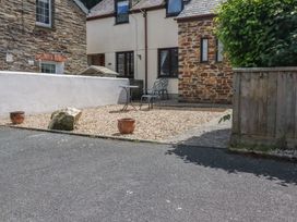 An outdoor space with a table and chairs at Stowaway Cottage in Padstow