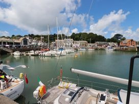 A harbor with boats and buildings at Stowaway Cottage Padstow