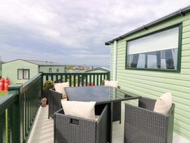 An outdoor seating area with a table and chairs at 18 Eden Heights in St Andrews