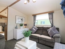 A living room with a sofa and coffee table at 18 Eden Heights St Andrews