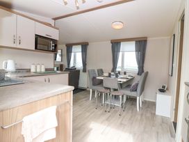 A kitchen and dining area with a table and chairs at 18 Eden Heights St Andrews