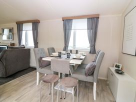 A dining area with table and chairs at 18 Eden Heights St Andrews