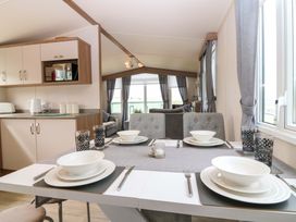 A dining room with table set for meals at 18 Eden Heights St Andrews