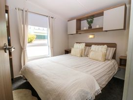 A bedroom with a bed and bedside table at 18 Eden Heights in St Andrews