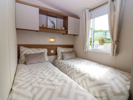 A bedroom with two beds and a window at 18 Eden Heights St Andrews