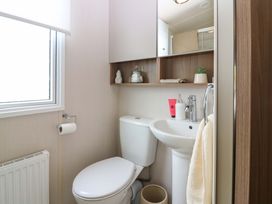 A bathroom with a toilet and sink at 18 Eden Heights St Andrews