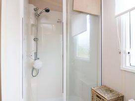 A shower area with a basket at 18 Eden Heights St Andrews