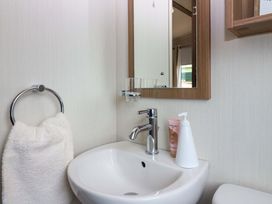 A bathroom with a sink and mirror at 18 Eden Heights in St Andrews