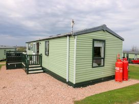 A mobile home with a deck and gas cylinders at 18 Eden Heights in St Andrews
