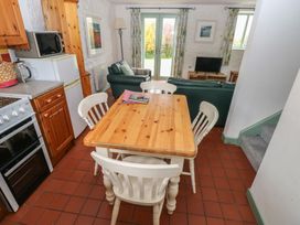 A kitchen with a dining area and living room space at Swallow Cottage Cowbridge