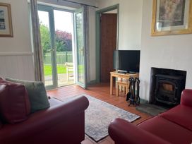 A living room with a sofa and television at Wren Cottage in Cowbridge