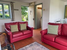 A living room with sofas and a door leading to the kitchen at Wren Cottage in Cowbridge