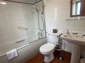 A bathroom with shower and bathtub at Wren Cottage Cowbridge