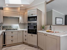 A kitchen with cabinets and appliances at Elwy 3.0 Pet in Llandyrnog