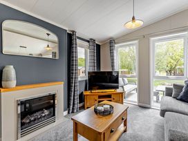 A living room with a sofa and fireplace at Elwy 3.0 Pet in Llandyrnog