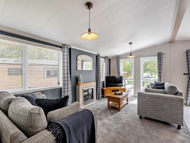 A living room with sofa and television at Elwy 3.0 Pet in Llandyrnog