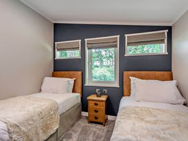 A bedroom with two beds and a nightstand at Elwy 3.0 Pet in Llandyrnog