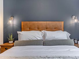 A bedroom with bed and bedside table at Elwy 3.0 Pet, Llandyrnog