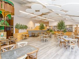 A dining room with tables and chairs at Pine Lodge Spa Carlton Miniott near Thirsk