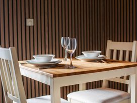 A dining room table set with plates and glasses at Pine Lodge Spa Pet Thirsk