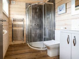 A bathroom with shower, toilet, and sink at Pine Lodge Spa Pet Thirsk
