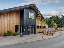 A building entrance with tables and chairs at Landal Woodland Lakes Carlton Miniott near Thirsk