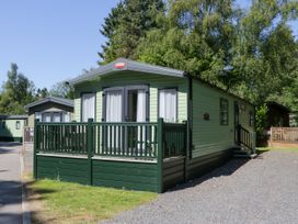 A green caravan with a deck at 51 Calgarth Park in Troutbeck