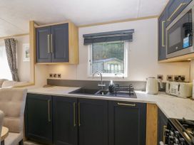 A kitchen with a sink and appliances at 51 Calgarth Park in Troutbeck