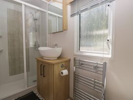 A bathroom with a shower and sink at 51 Calgarth Park in Troutbeck
