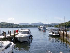 Boats moored at a dock with mountains in the background at 51 Calgarth Park, Troutbeck