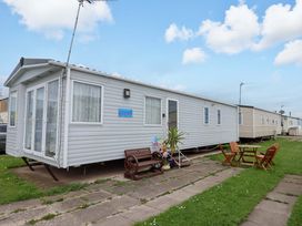 A mobile home with outdoor seating at 15 Cherry Tree walk in Rhyl