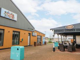 An outdoor area with buildings and seating at 15 Cherry Tree walk in Rhyl