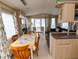 A living room with a dining table and sofa at 15 Cherry Tree walk in Rhyl