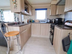 A kitchen with cabinets and appliances at 15 Cherry Tree walk Rhyl