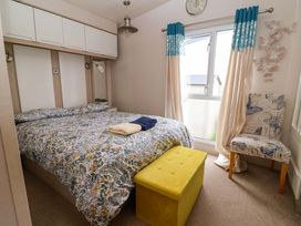 A bedroom with a bed and a chair at 15 Cherry Tree walk in Rhyl